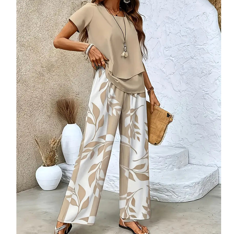🌿 Set două piese femei – imprimeu frunze + pantaloni cu picior larg. Elegant, confortabil și perfect pentru vară! 🔥 Plătești DOAR la livrare în România. ✅ Comandă acum – stoc limitat!